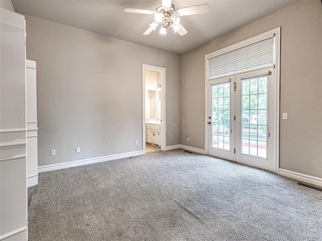 spare room with baseboards, carpet, a ceiling fan, and visible vents