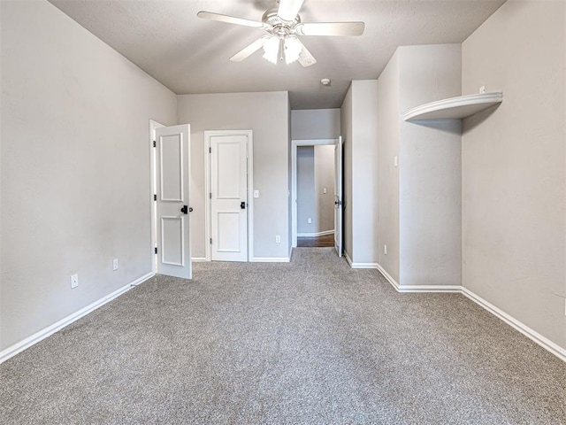 unfurnished bedroom featuring baseboards, carpet flooring, and ceiling fan