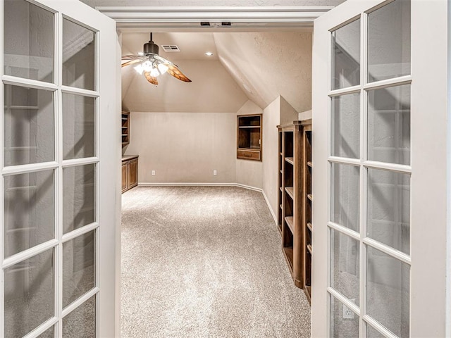 bonus room with ceiling fan, french doors, carpet, lofted ceiling, and visible vents