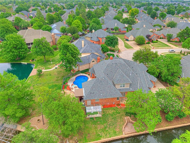birds eye view of property featuring a water view and a residential view