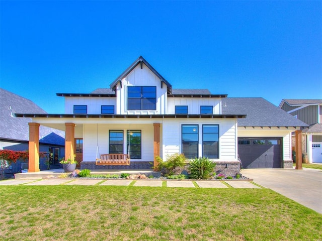 view of front of property with concrete driveway, a front lawn, board and batten siding, covered porch, and brick siding
