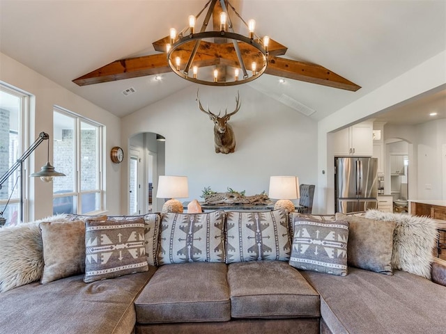 living room featuring vaulted ceiling with beams, visible vents, arched walkways, and a chandelier