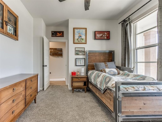 bedroom with light colored carpet and baseboards