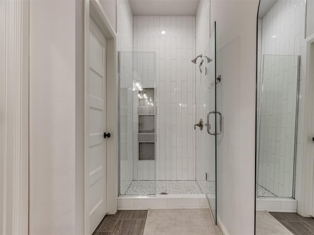 bathroom featuring tile patterned flooring and a stall shower