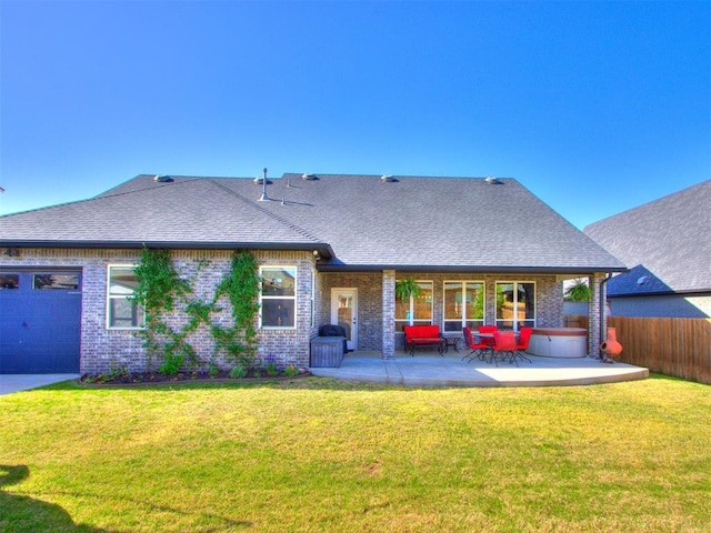 rear view of property featuring fence, a lawn, and brick siding