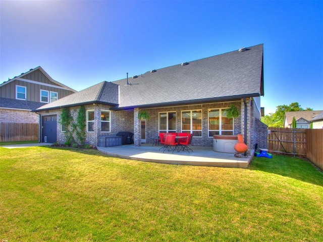 back of property with a fenced backyard, a yard, a patio, and a garage