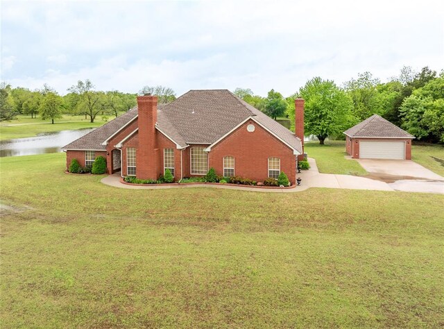 view of home's exterior with a garage, a chimney, a lawn, a water view, and an outbuilding