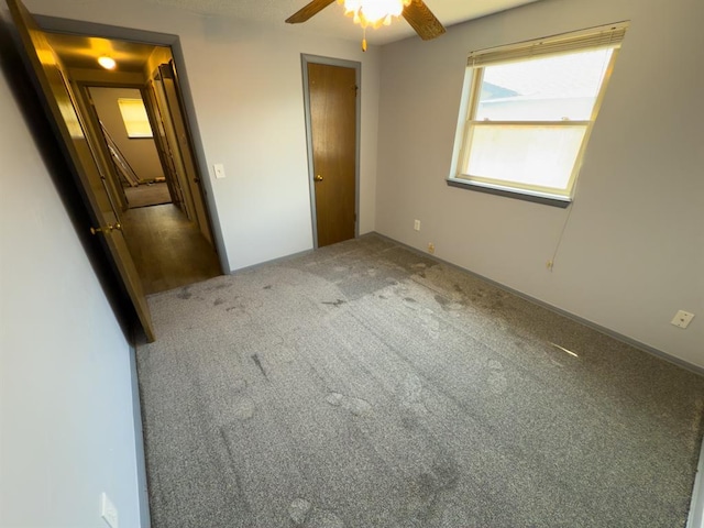 unfurnished bedroom featuring carpet and ceiling fan