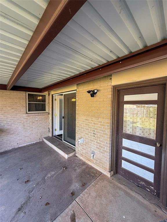 property entrance with brick siding
