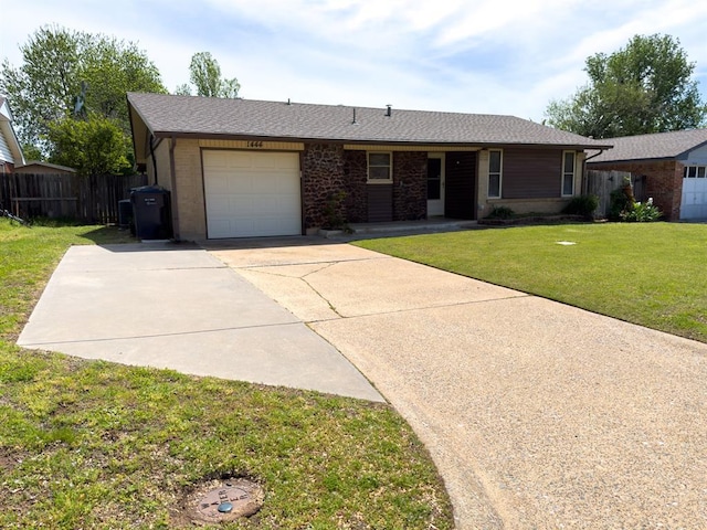 ranch-style home featuring concrete driveway, a front lawn, an attached garage, fence, and brick siding