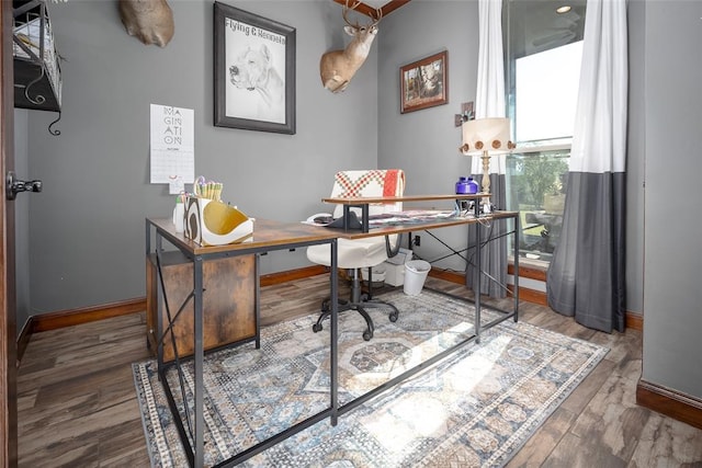 office area with baseboards and wood finished floors