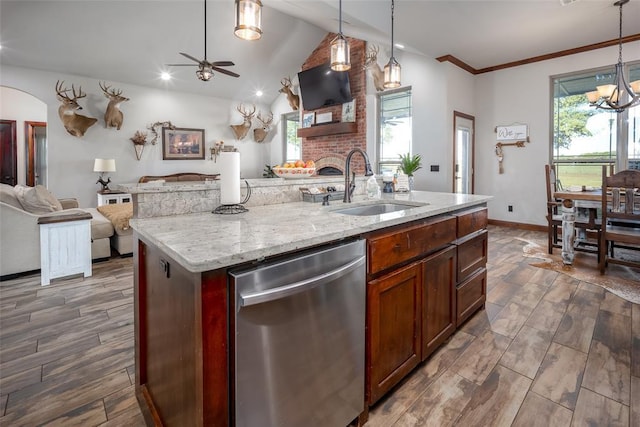 kitchen featuring open floor plan, a sink, ceiling fan with notable chandelier, dishwasher, and a wealth of natural light