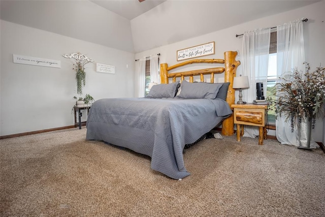 bedroom with carpet floors, baseboards, and vaulted ceiling