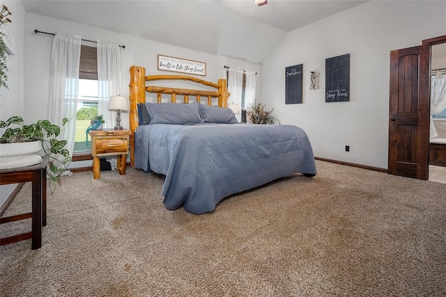 carpeted bedroom with baseboards and vaulted ceiling
