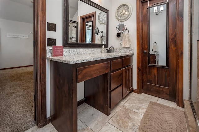 bathroom with baseboards and vanity