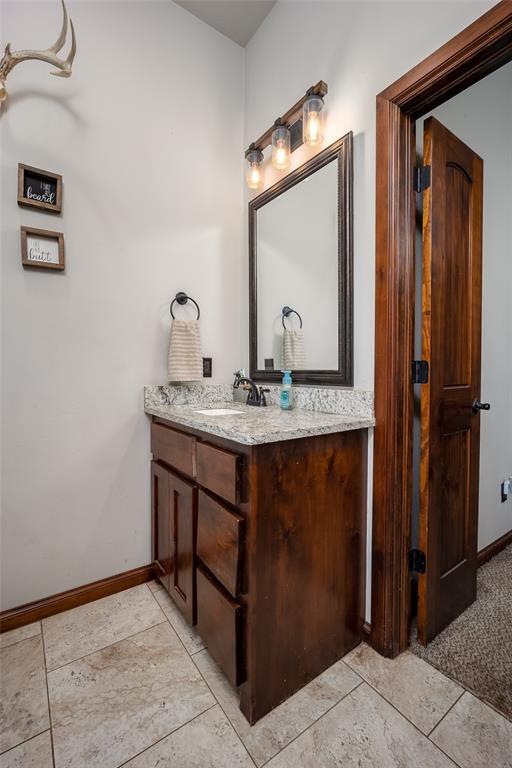 bathroom featuring baseboards and vanity