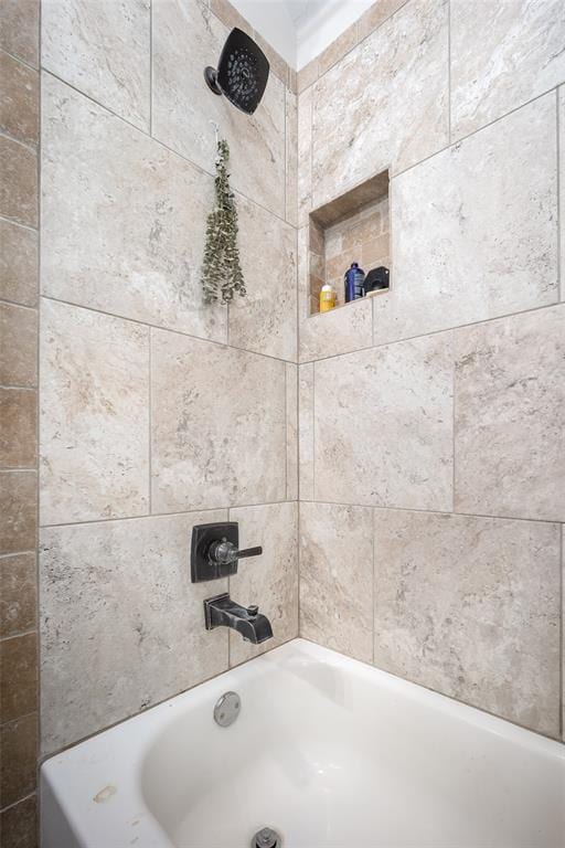 bathroom featuring a washtub and walk in shower