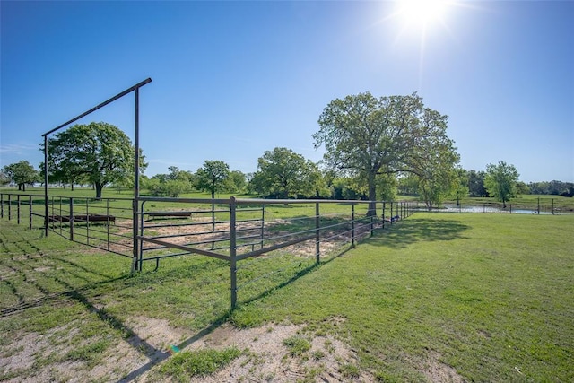 view of yard featuring a water view, a rural view, and fence