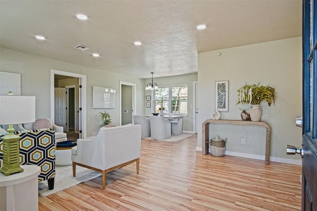 living area featuring recessed lighting, baseboards, visible vents, and light wood-type flooring
