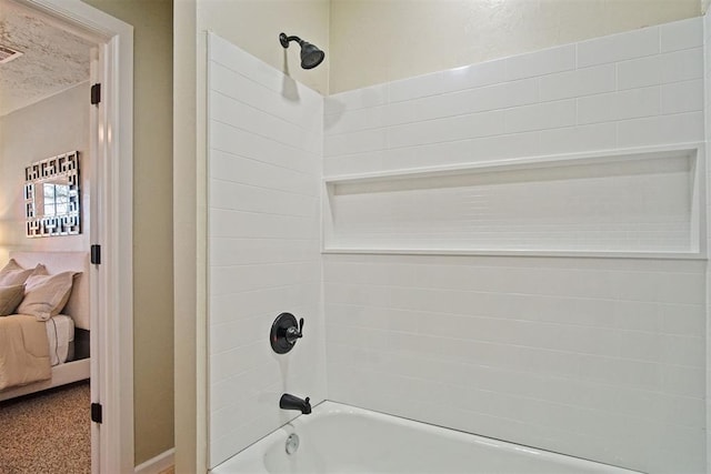 ensuite bathroom featuring connected bathroom and shower / tub combination