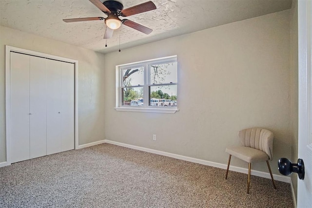 unfurnished bedroom featuring a textured ceiling, a closet, ceiling fan, baseboards, and carpet flooring
