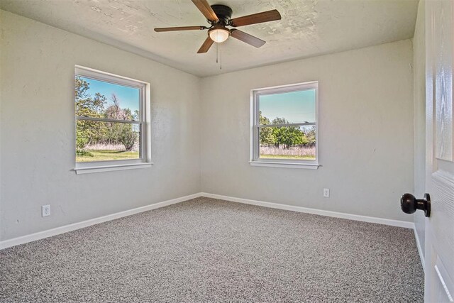 unfurnished room featuring carpet, a ceiling fan, and baseboards