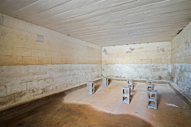 interior space with concrete block wall