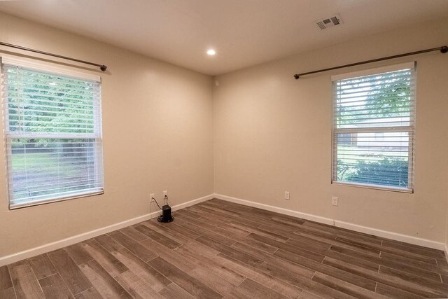 spare room with recessed lighting, baseboards, visible vents, and wood finished floors