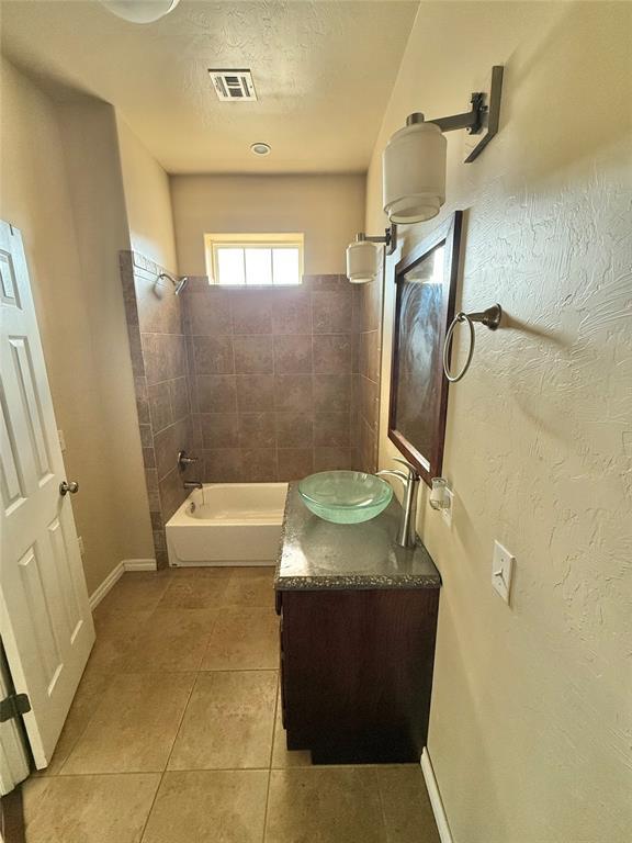 full bathroom with tile patterned flooring, visible vents, vanity, tub / shower combination, and baseboards