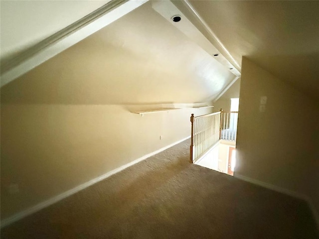 bonus room featuring lofted ceiling, baseboards, and carpet floors