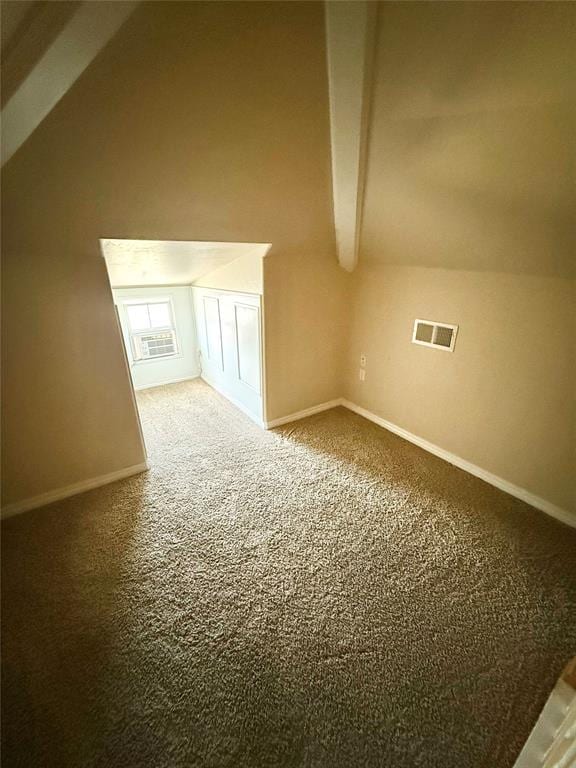 additional living space with lofted ceiling with beams, baseboards, visible vents, and carpet floors