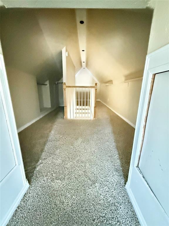 bonus room featuring vaulted ceiling and baseboards