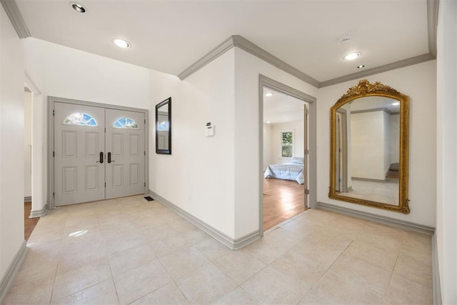 entrance foyer with recessed lighting, crown molding, baseboards, and light tile patterned floors