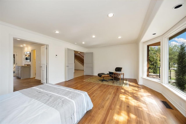 bedroom with recessed lighting, light wood-style floors, and crown molding