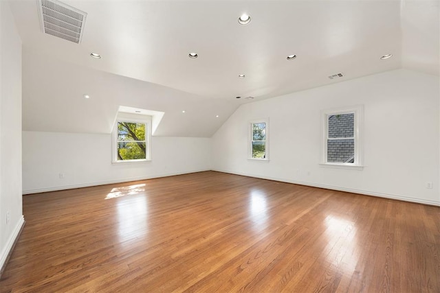bonus room with lofted ceiling, plenty of natural light, and visible vents