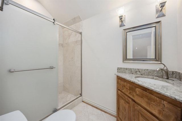 bathroom with lofted ceiling, vanity, toilet, and a stall shower