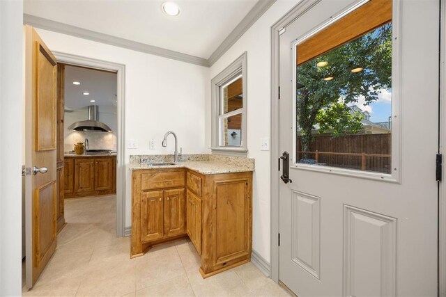 bar with a sink, light tile patterned flooring, recessed lighting, exhaust hood, and crown molding