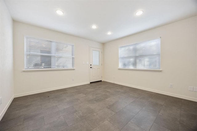 interior space featuring baseboards, a wealth of natural light, and recessed lighting