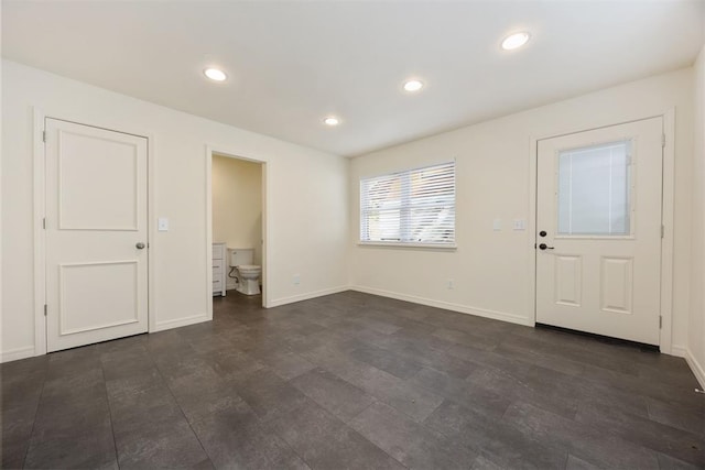 foyer with baseboards and recessed lighting