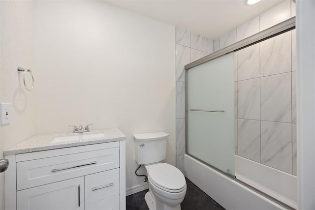 full bathroom featuring toilet, vanity, and combined bath / shower with glass door