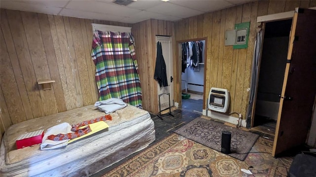 121 N High Ave, Shawnee, OK 74801 - bedroom with wooden walls, a paneled ceiling, heating unit, visible vents, and electric panel