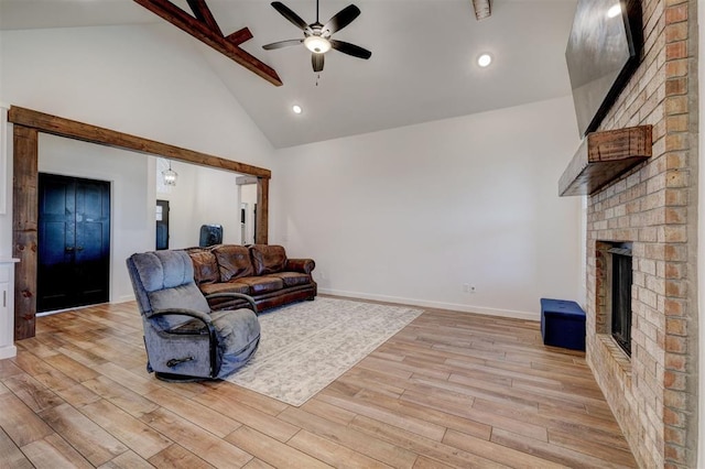 13513 NW 1st St, Yukon, OK 73099 - living room with beam ceiling, a fireplace, high vaulted ceiling, light wood-style flooring, and a ceiling fan
