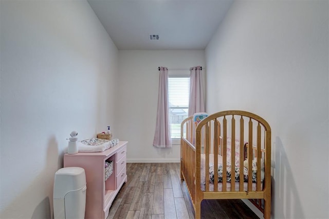 13513 NW 1st St, Yukon, OK 73099 - bedroom with visible vents, light wood-style floors, and baseboards