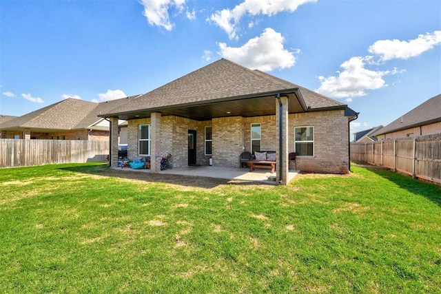 13513 NW 1st St, Yukon, OK 73099 - rear view of property featuring a lawn, brick siding, a fenced backyard, and a patio area