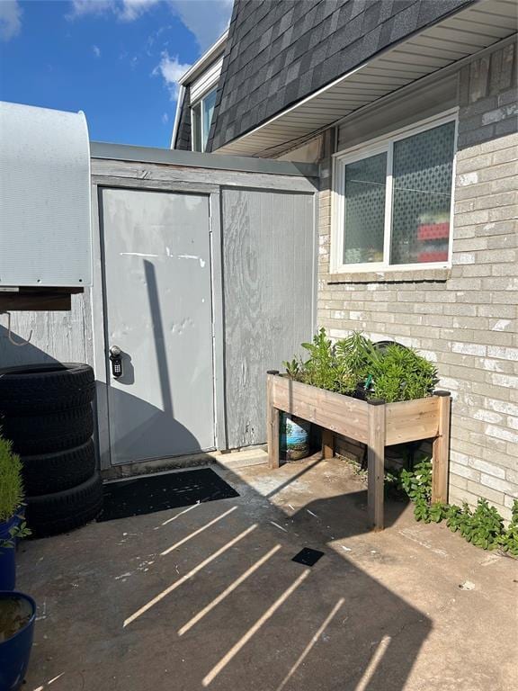 215 Justin Dr, Norman, OK 73071 - view of patio / terrace with a storage unit and an outdoor structure
