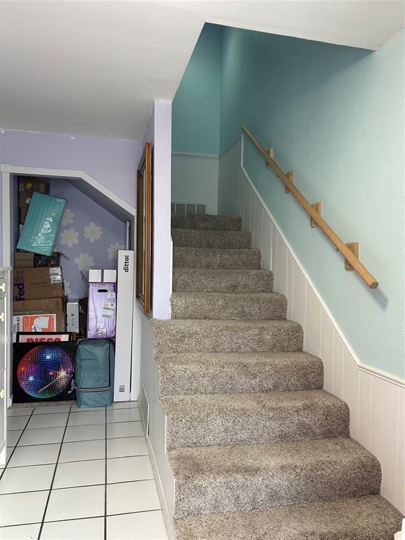 215 Justin Dr, Norman, OK 73071 - stairs featuring wainscoting and tile patterned flooring
