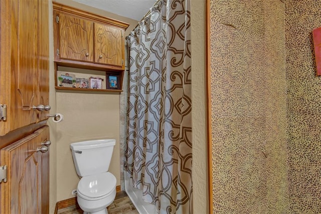 full bathroom featuring toilet and curtained shower