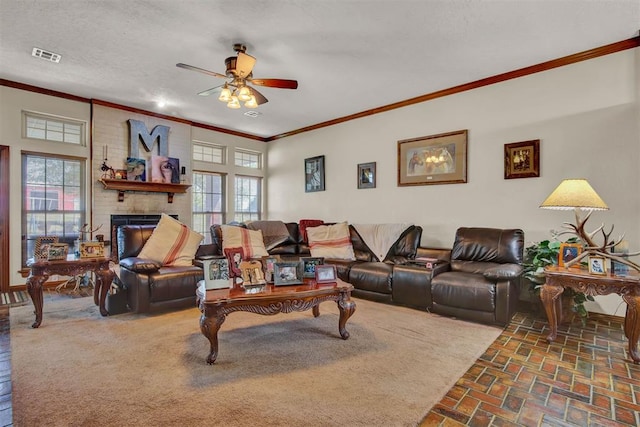 living room with visible vents, ceiling fan, crown molding, brick floor, and a fireplace