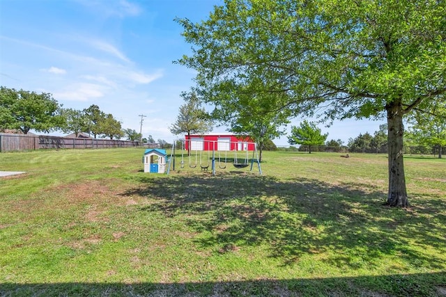 view of yard with exterior structure, an outdoor structure, and fence