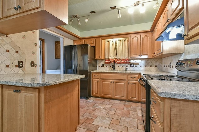 1637 NE 9th St, Moore, OK 73160 - kitchen with black appliances, backsplash, under cabinet range hood, and stone finish floor